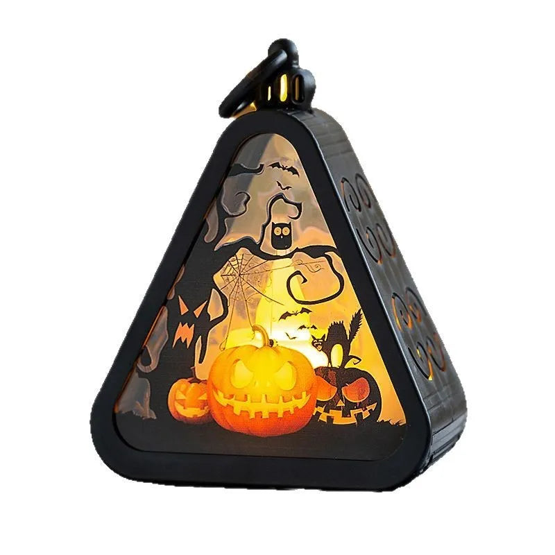 Halloween pumpkin lantern decoration in four colour designs on a table.