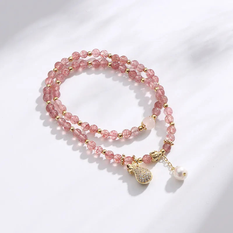 Geometric strawberry quartz crystal bracelet for women on a white background.