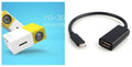 Compact black HD 1080P mini digital projector with UK power plug on white background
