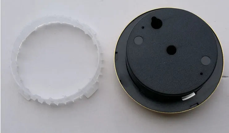 Analog thermometer and hygrometer with silver aluminium ring and dial showing temperature and humidity scales.