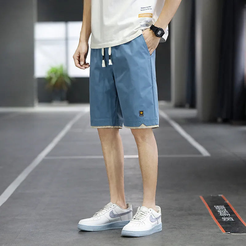 Korean style straight leg loose beach shorts in polyester, shown in green on a mannequin.