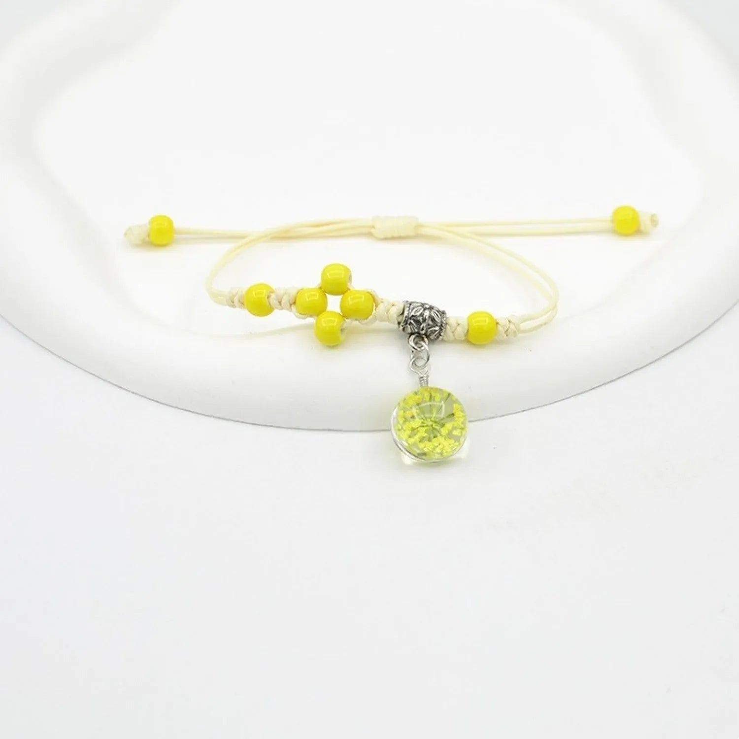 Hand-woven glass bracelet with large beads containing real dried flowers, shown in multiple colour options.