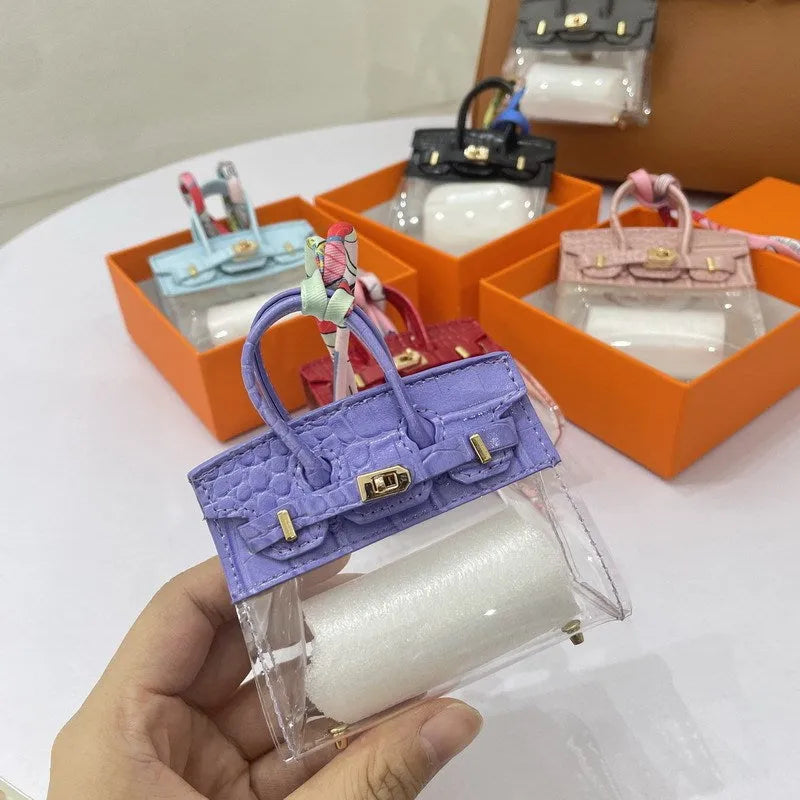 A women's fashion car key case made of artificial leather, shown in a crocodile pattern design.