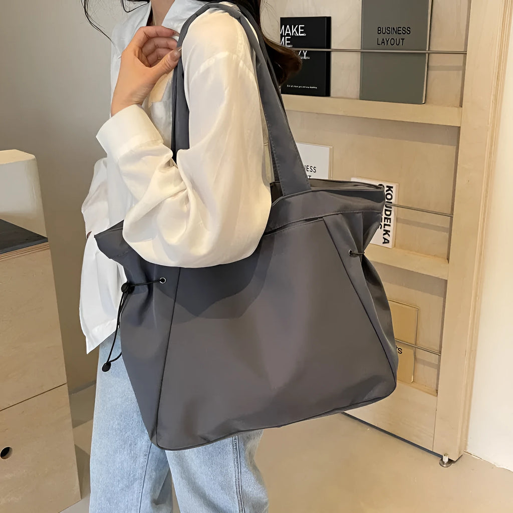 Soft foldable Oxford cloth shoulder tote bag in a street style, shown in various colours.