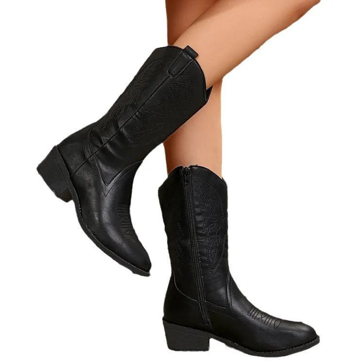 Women's black mid-calf Martin boots with chunky heel, pointed toe, and hollow out design detail on a white background.