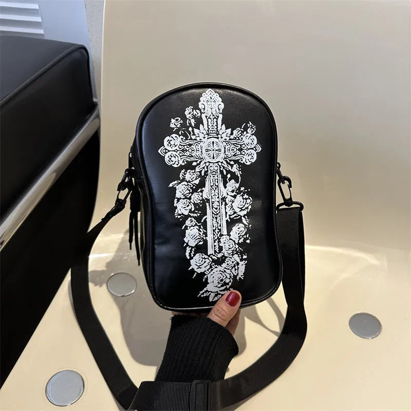 Black mini square crossbody bag with orange Halloween graffiti print of cartoon pumpkin, ghost, and bat.