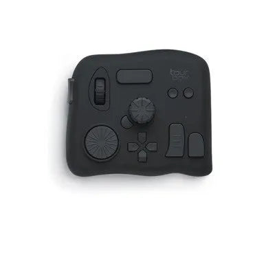 TourBox NEO black video editing controller with dials and buttons on a desk.