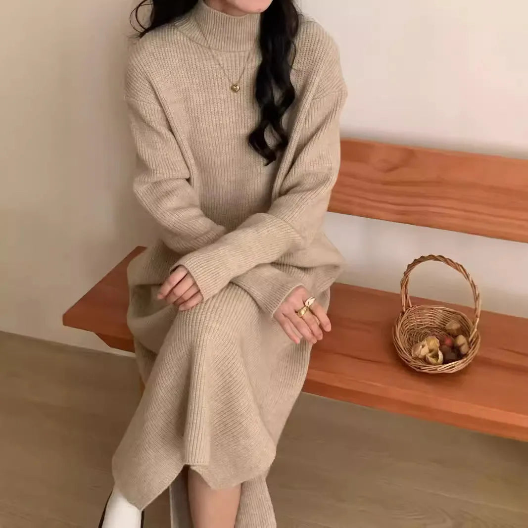 Woman wearing a milky white half turtleneck long sleeve knitted midi dress with a high waist.