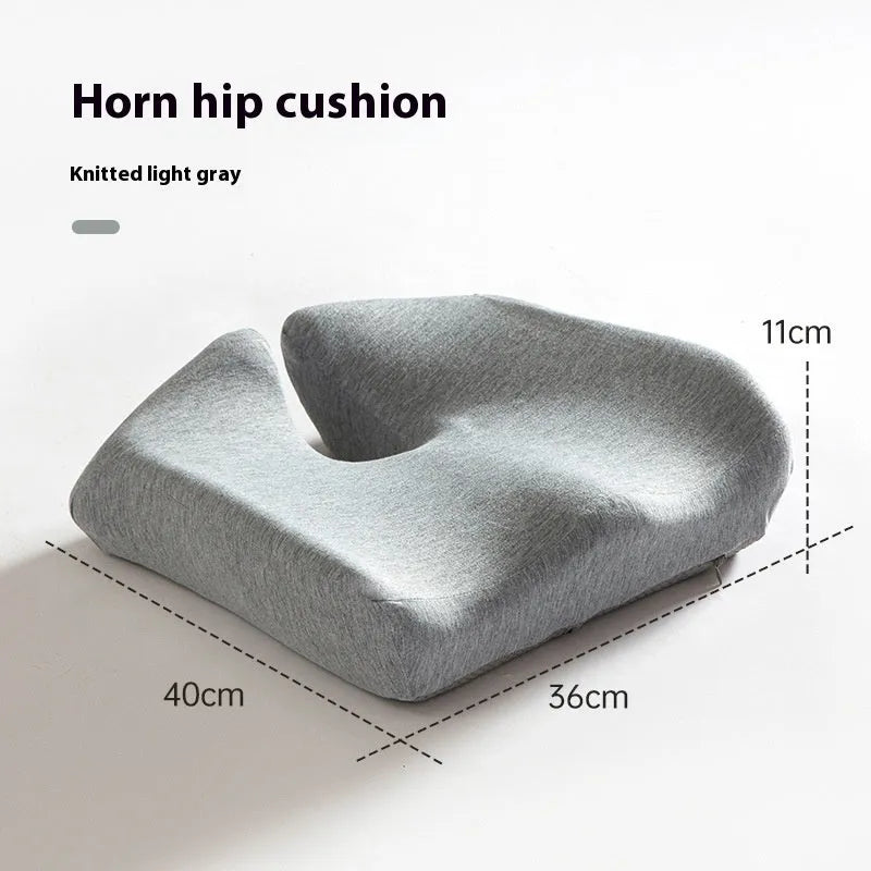 Dark grey memory foam office chair cushion for lumbar support on a desk chair.