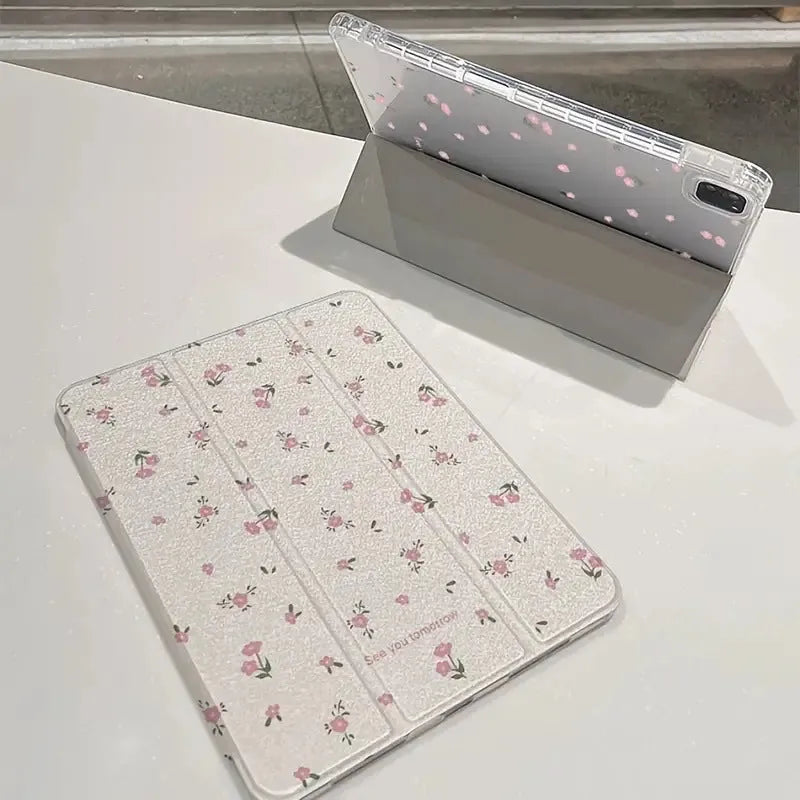 Transparent tri-fold Apple iPad case with cartoon floral print showing magnetic stand function.