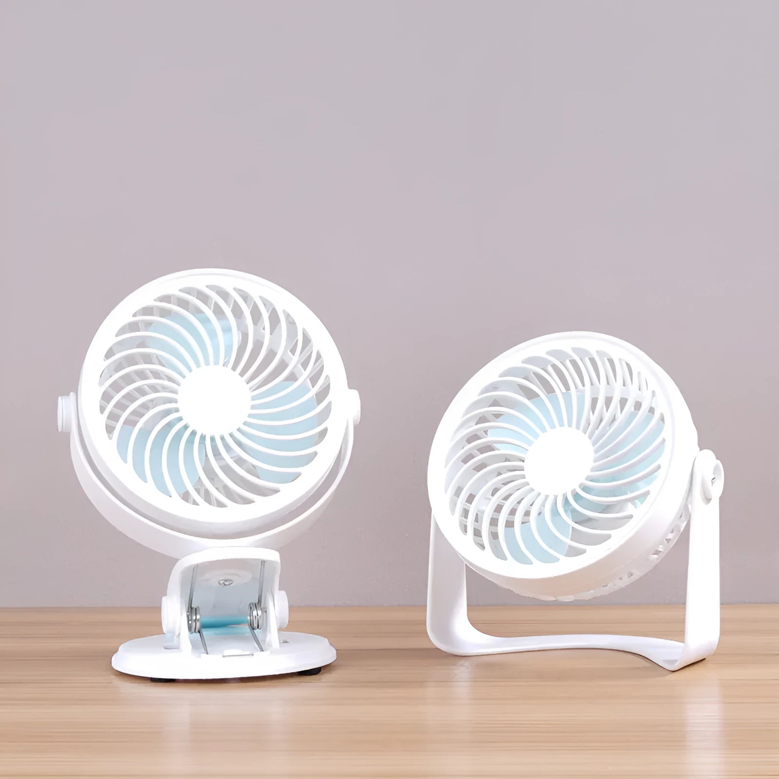 Small white USB desktop fan shown as a clip-on model and a floor-standing model on a wooden desk.