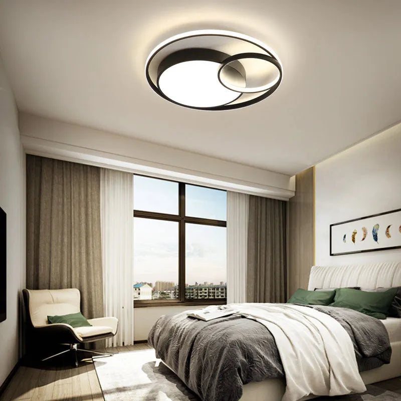 Modern minimalist round LED ceiling light in white with wrought iron frame and acrylic shade.