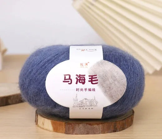 Ball of mohair yarn for DIY scarf knitting in one of 34 colours, including white, pink, blue, and green.