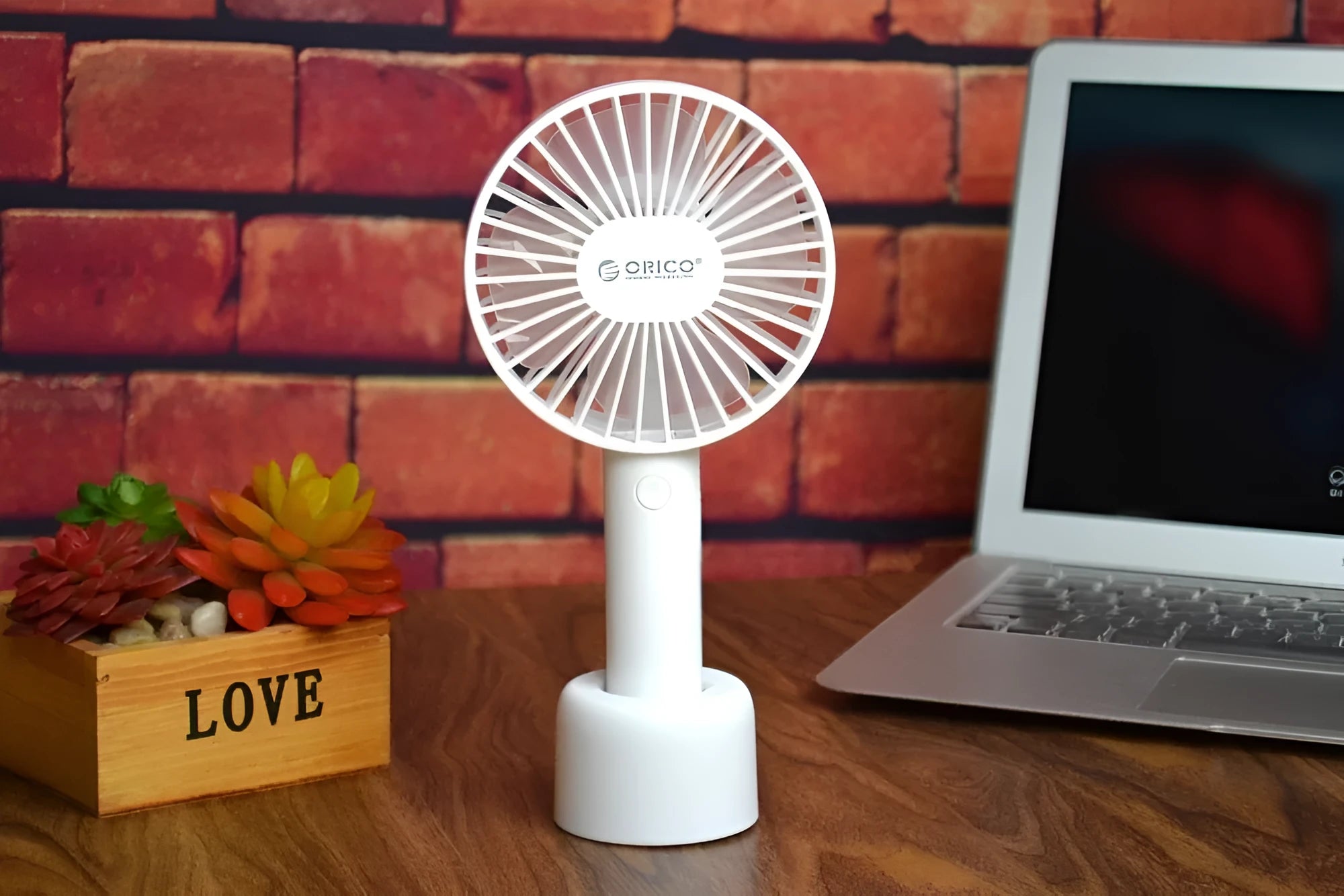 White ORICO FH1 portable USB rechargeable desk fan with three-speed buttons and compact handheld design.