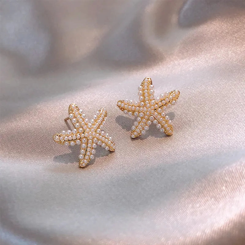 Gold pineapple and starfish pearl Korean style drop earrings with alloy electroplating and inlaid gems.