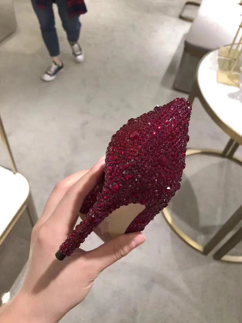 Gold women's pointed toe stiletto heels with rhinestone and sequin decoration on a 7cm heel.