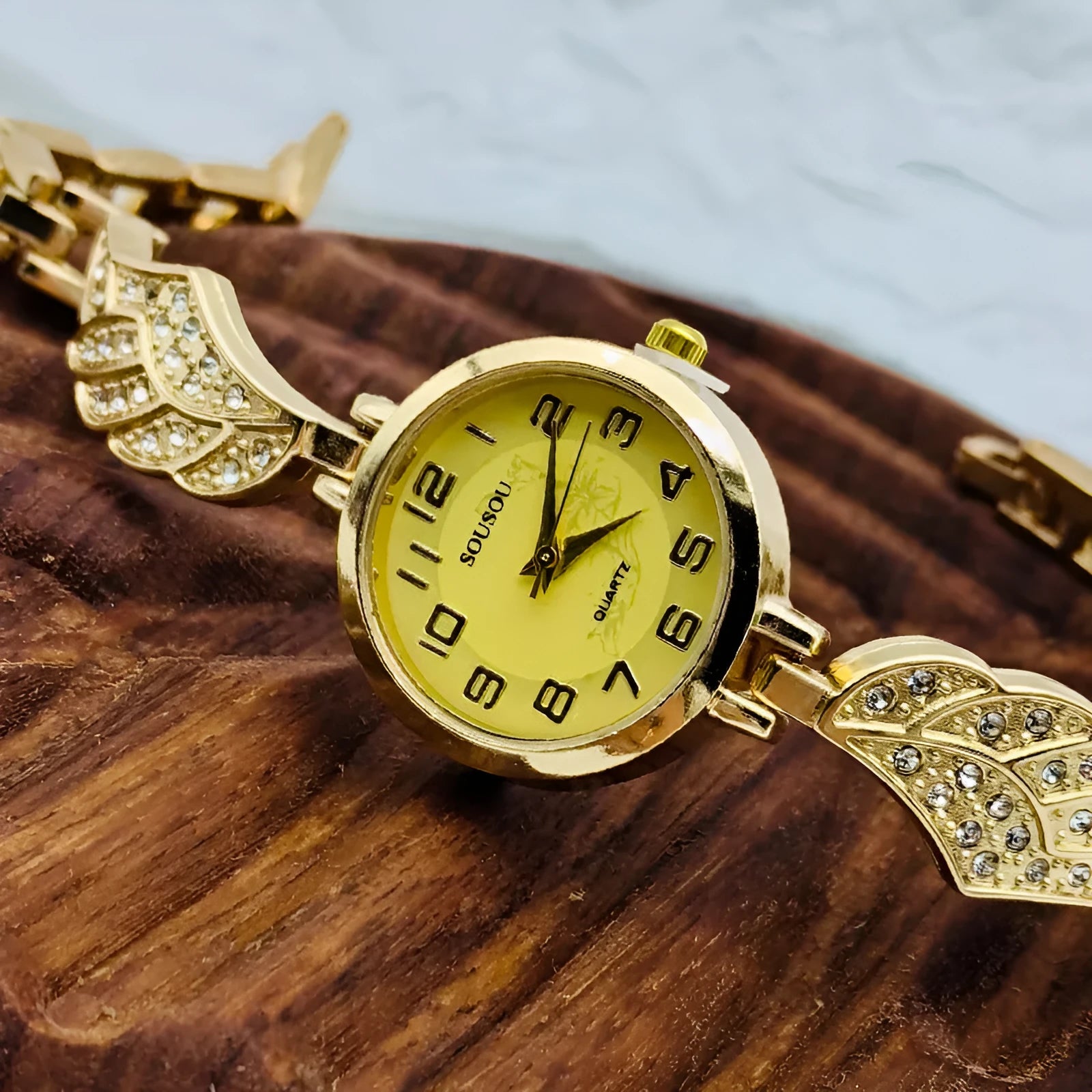Women's stainless steel watch with round dial, available in gold, golden white, or golden black surface options