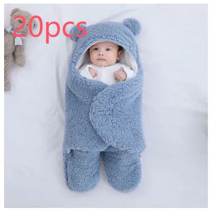 Baby quilted sleeping bag wrapper in cotton blend fabric, shown in a light blue colour.