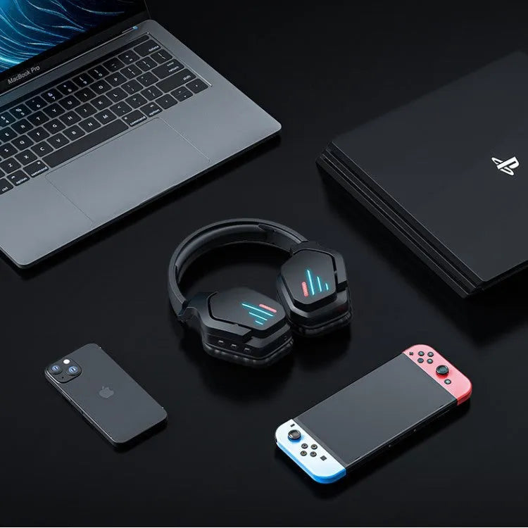 Luminous black wireless over-ear headphones with headband, shown with included 3.5mm cable and dust bag.