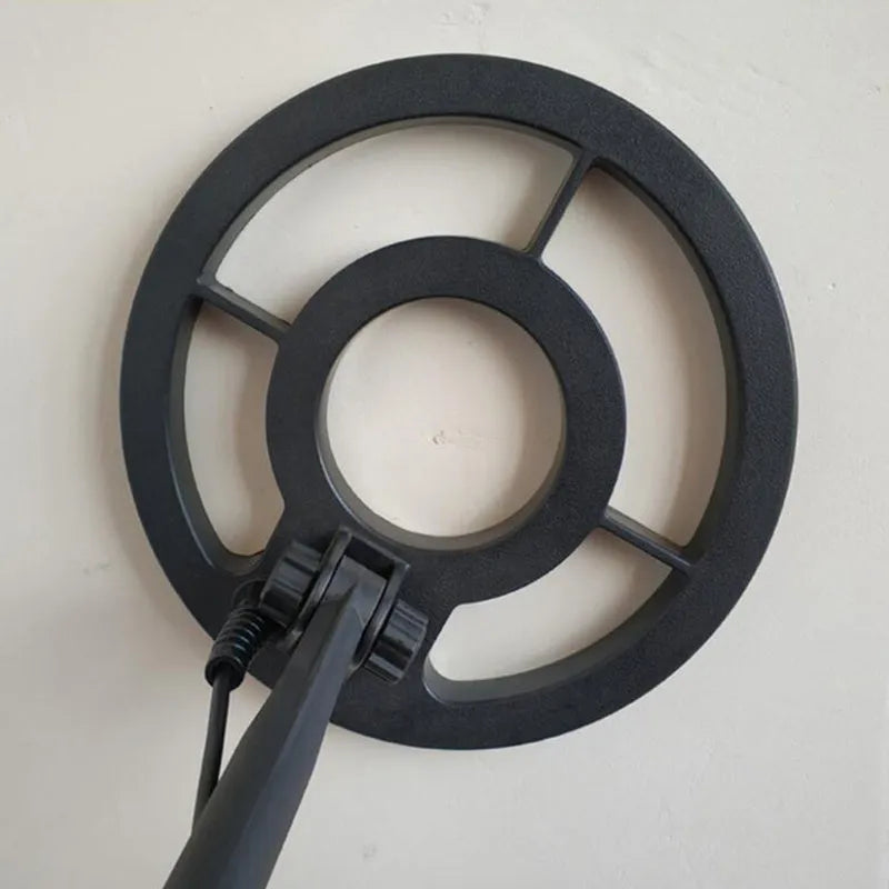 GC1028 black and yellow metal detector with LCD screen and adjustable pole on grass.