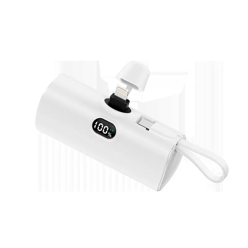 Capsule shaped digital display wireless power bank in multiple colours showing its compact size and built-in plug.