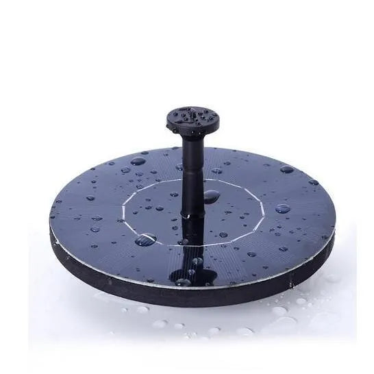 Black solar-powered fountain pump with multiple nozzles on a small pond or bird bath.