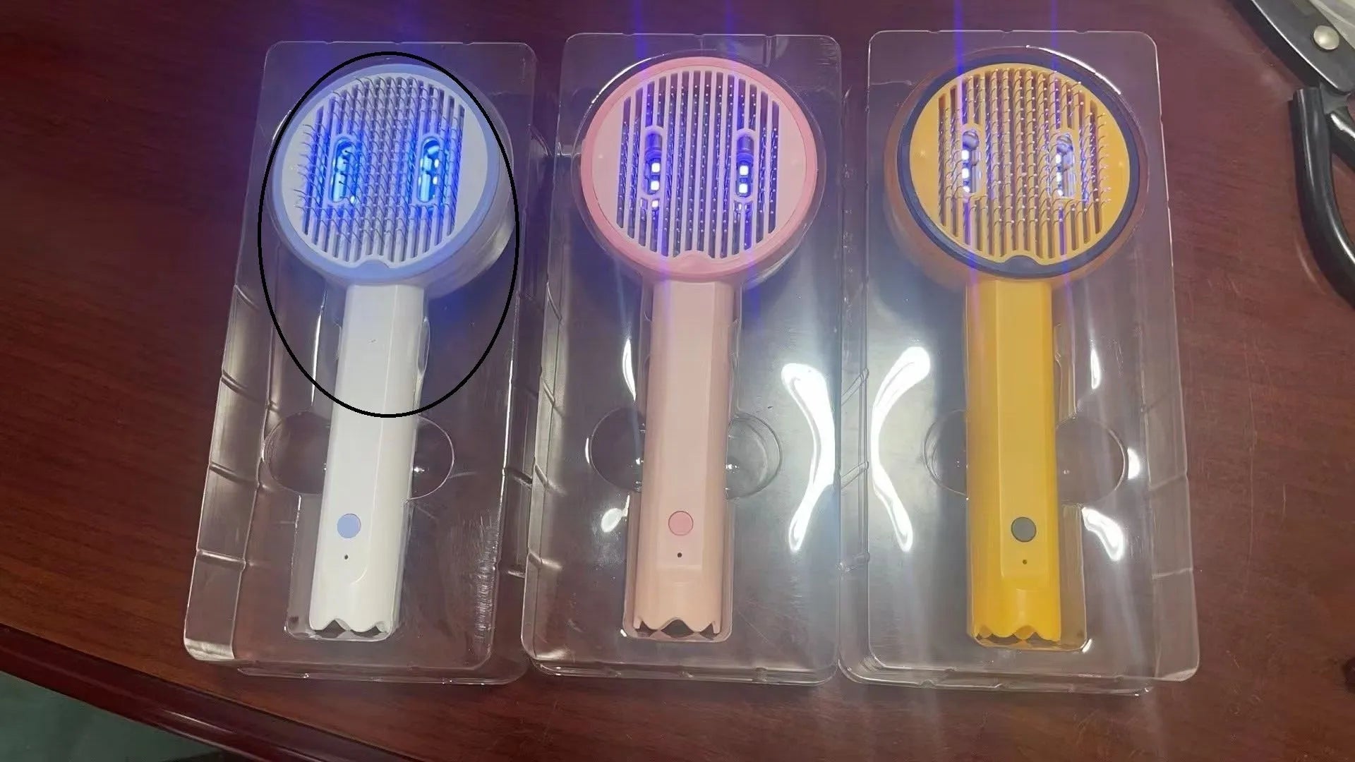 USB rechargeable UV sterilization pet comb for cats and dogs in pink, yellow, and white ABS plastic