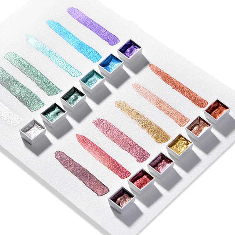 Boxed set of solid watercolour pigment blocks in pearlescent colours on a white background.