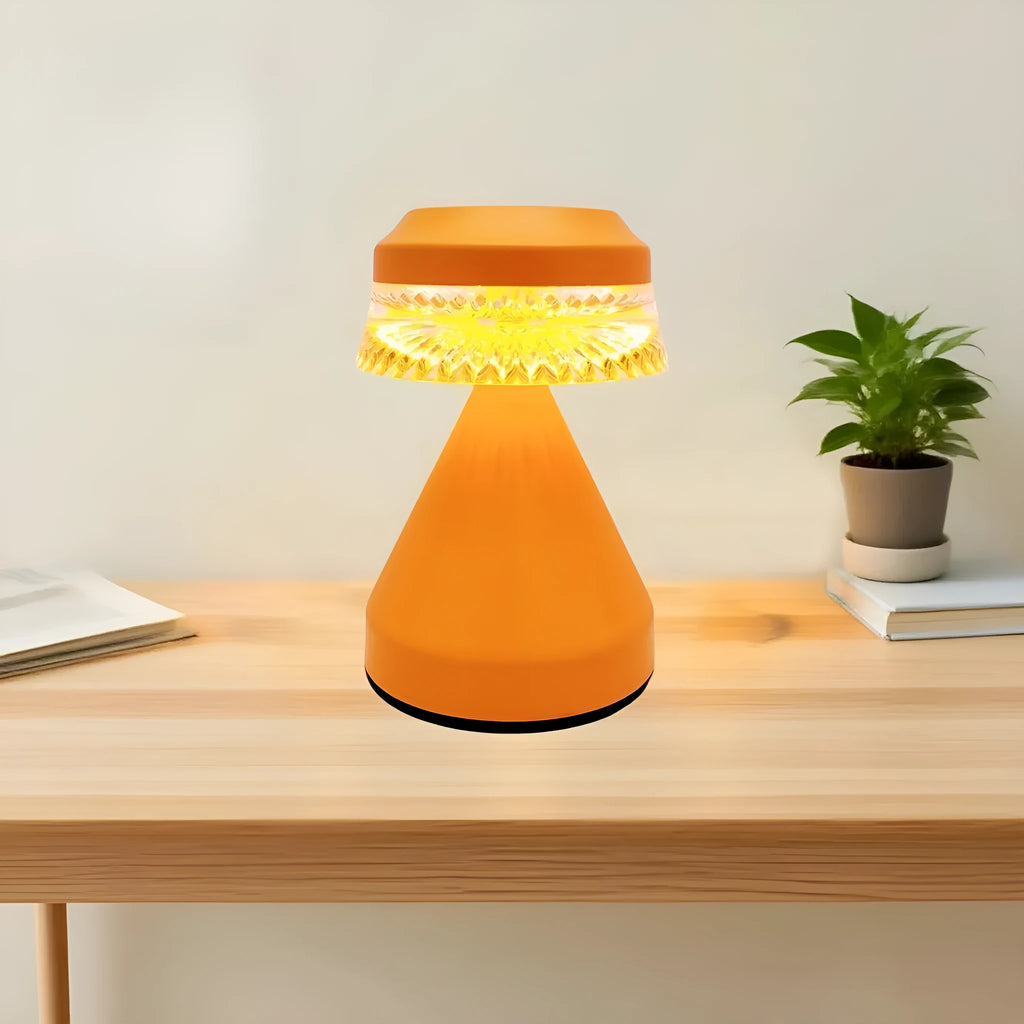 Compact USB rechargeable LED night light in black, brown, and orange colour options on a table.