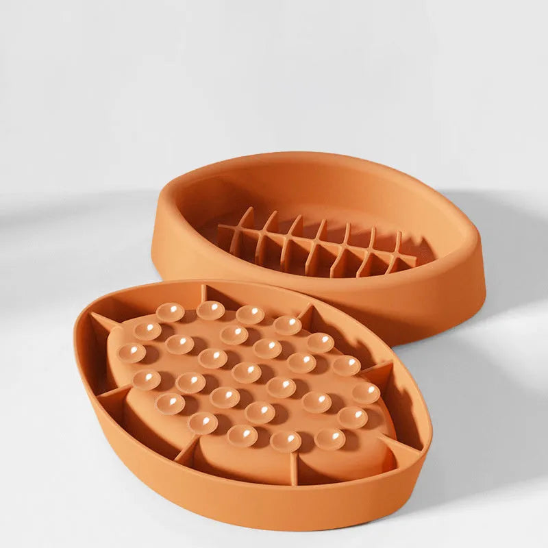 Blue silicone slow feeder pet bowl with suction cup base and internal maze pattern.