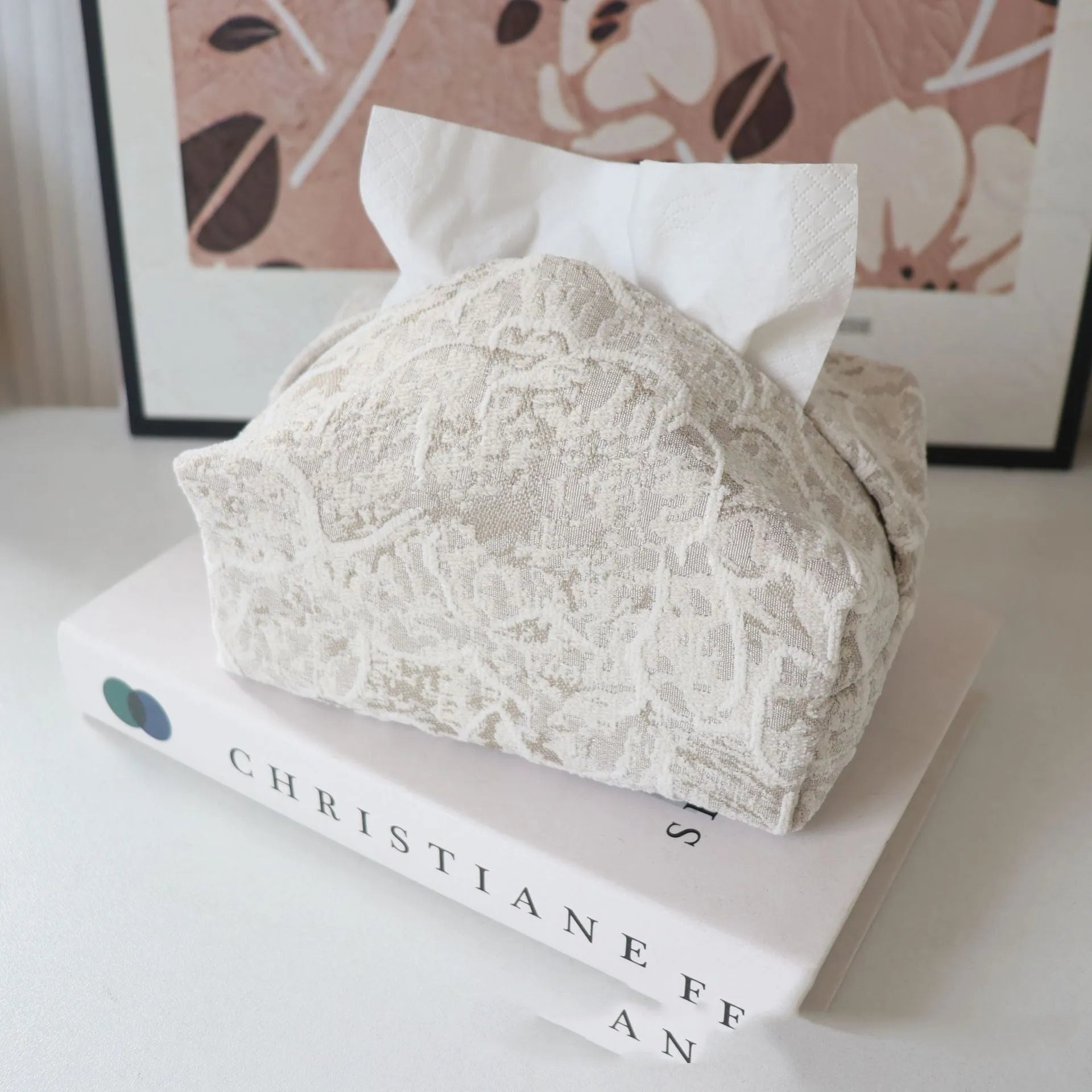 Chinese style floral cotton tissue box cover in beige, blue, and brown on a wooden table.