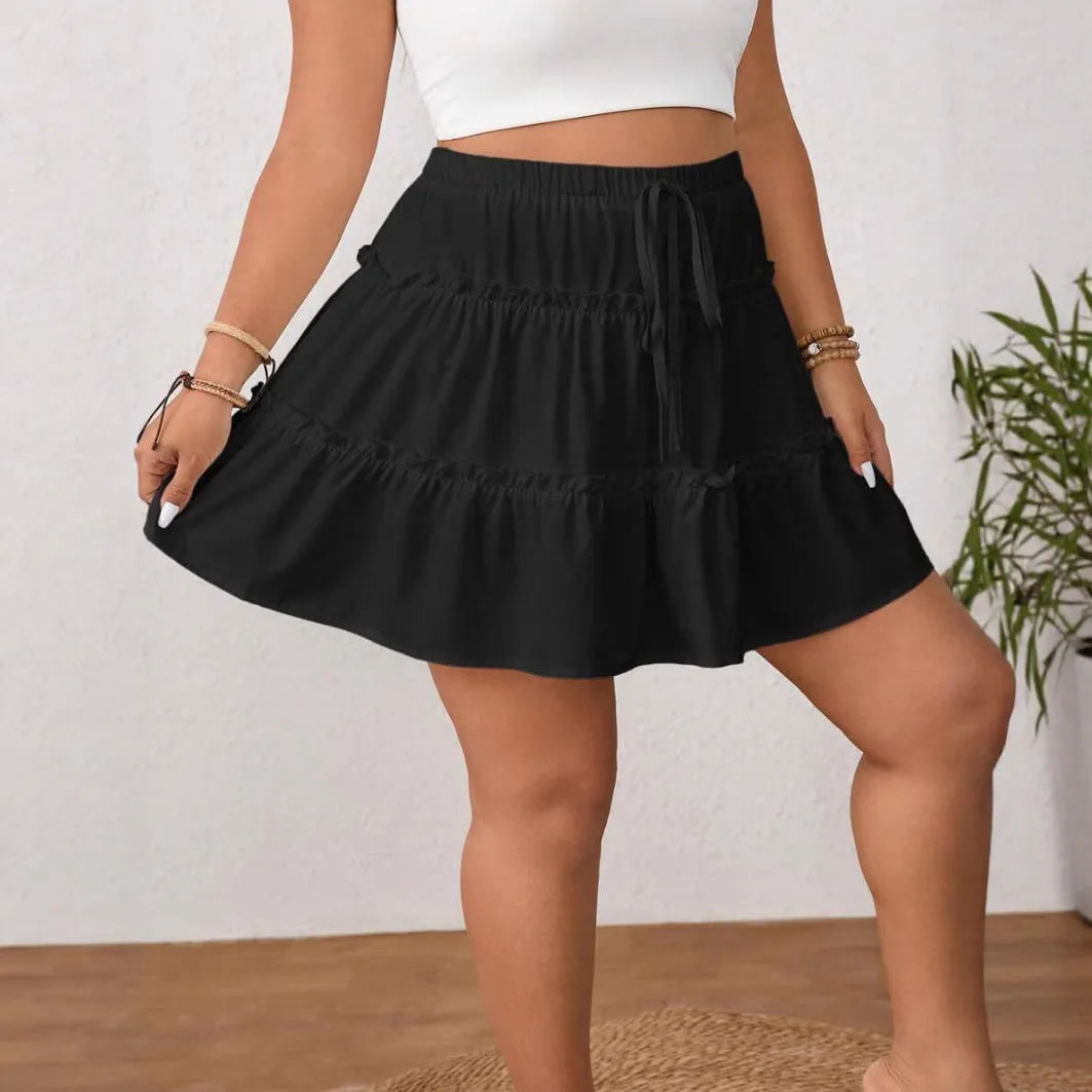 White pleated A-line skirt with lace-up front detail on a mannequin.