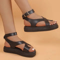 Women's white thick-soled Roman-style sandals with a buckle and loop-foot strap on a composite sole.