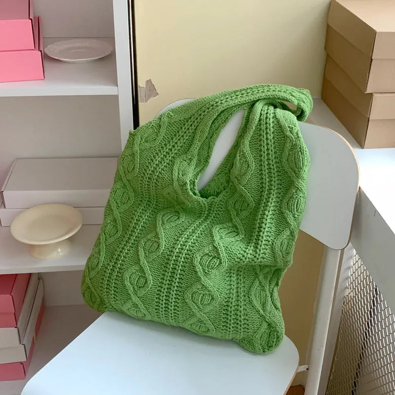 GWomen retro crochet shoulder tote bag in a solid colour, showing knitted texture and double strap connectors.