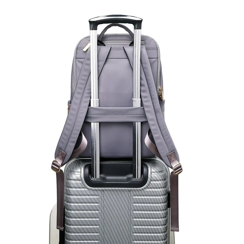 Large black oxford cloth women's backpack with anti-theft compartments and padded straps.