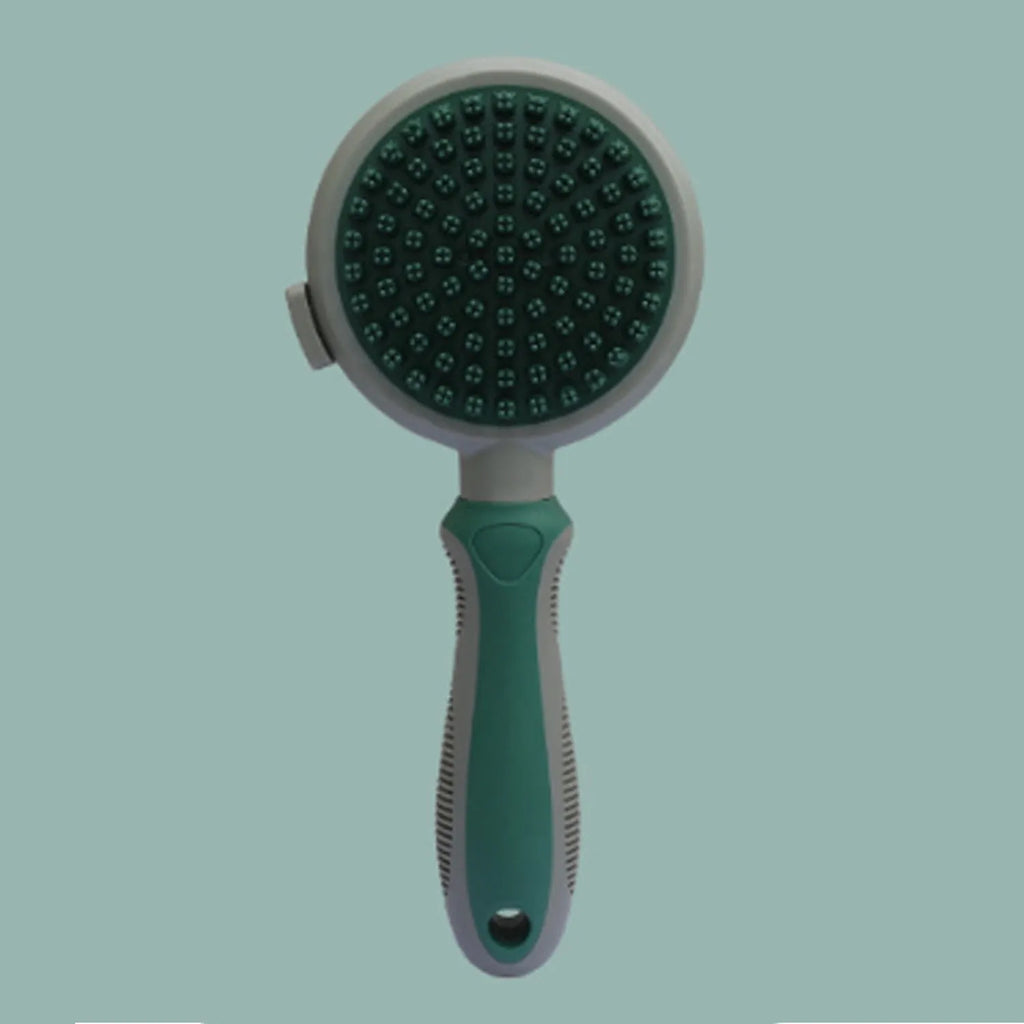 Green and pink double sided cat brush with release button showing brush and flea comb sides