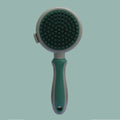 Green and pink double sided cat brush with release button showing brush and flea comb sides