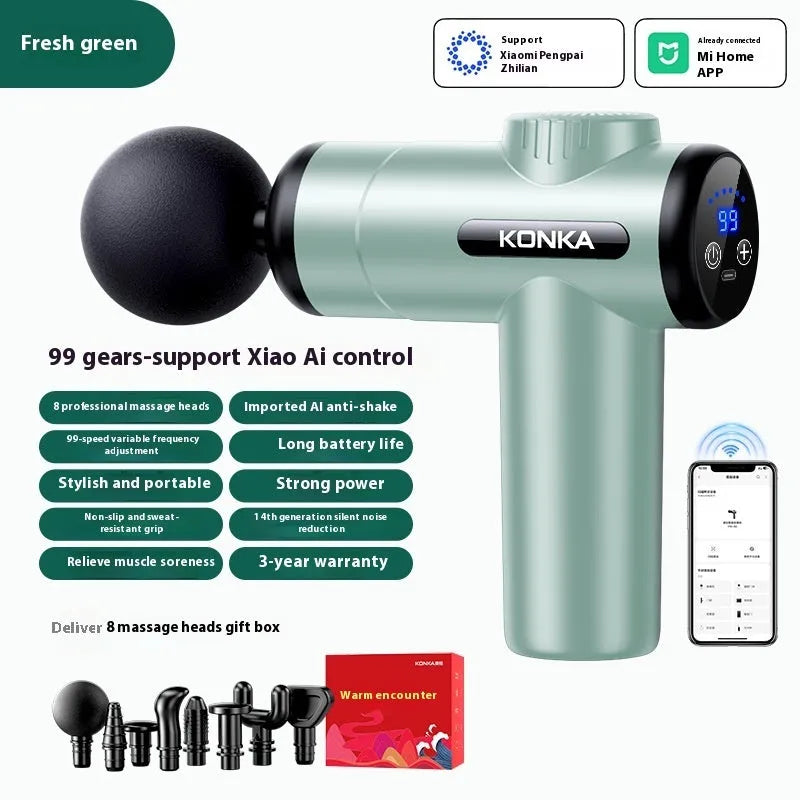 Konka V19 grey massage gun with multiple silicone attachment heads on a table.