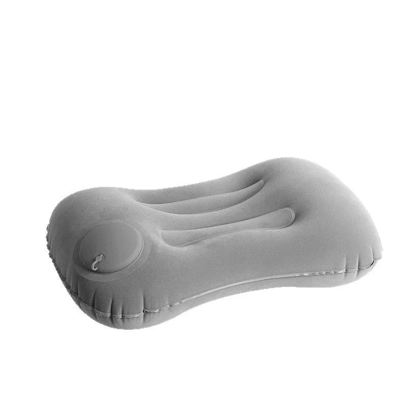 Grey press inflatable travel pillow showing size and flocking texture next to deflated state.