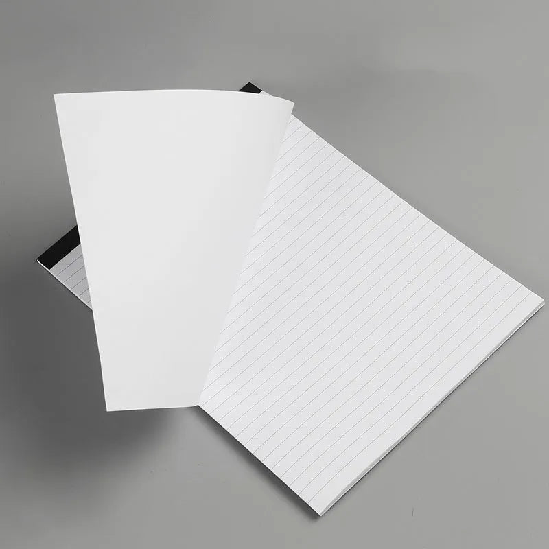 A4 wire-o bound tear-off notepad open on a table, showing ivory white grid pages.