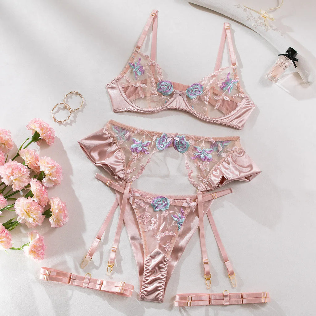 Light purple satin lingerie four-piece set with decorative embroidery on a hanger