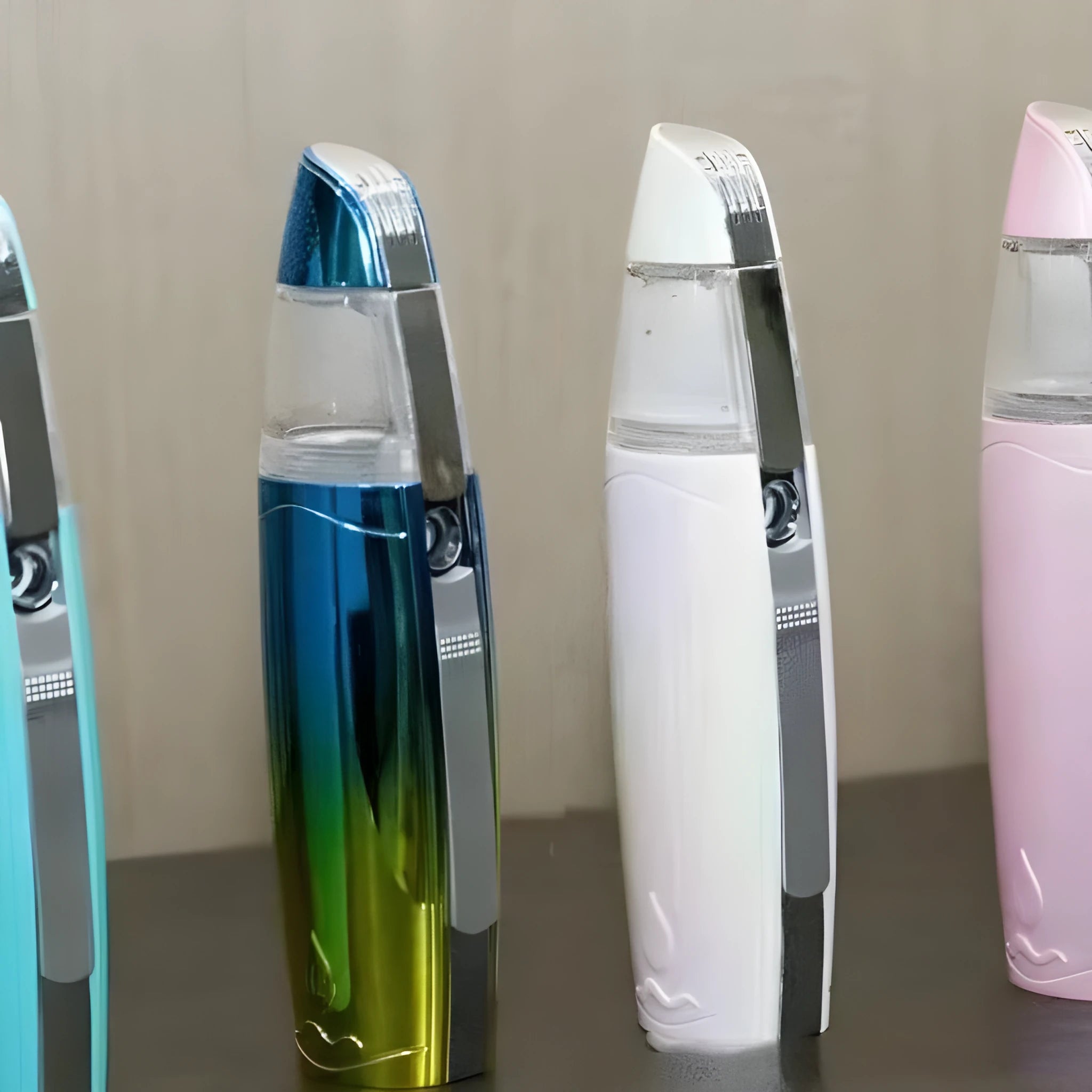 Peacock blue handheld facial steamer with USB charging port for skincare hydration.