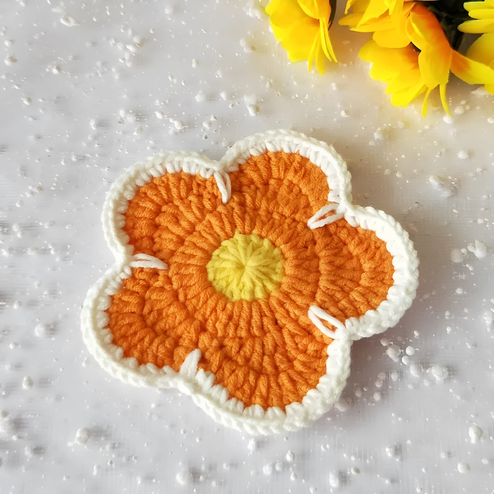 Colourful handmade cotton thread woven flower placemats on dining table