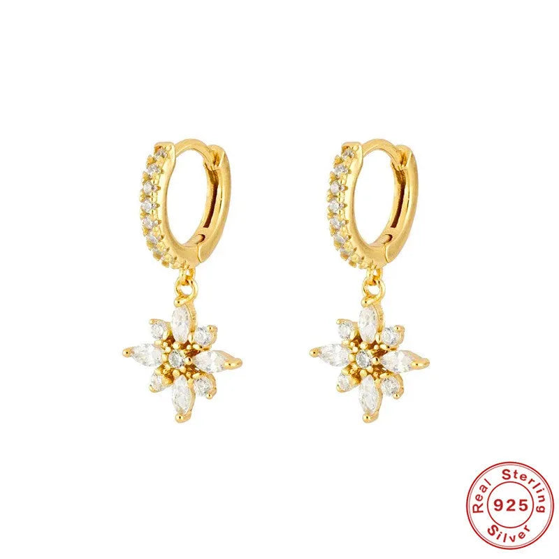 Pair of S925 sterling silver snowflake pendant earrings with gemstone inlay on a white background