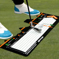 Black neoprene golf swing stance correction pad on grass