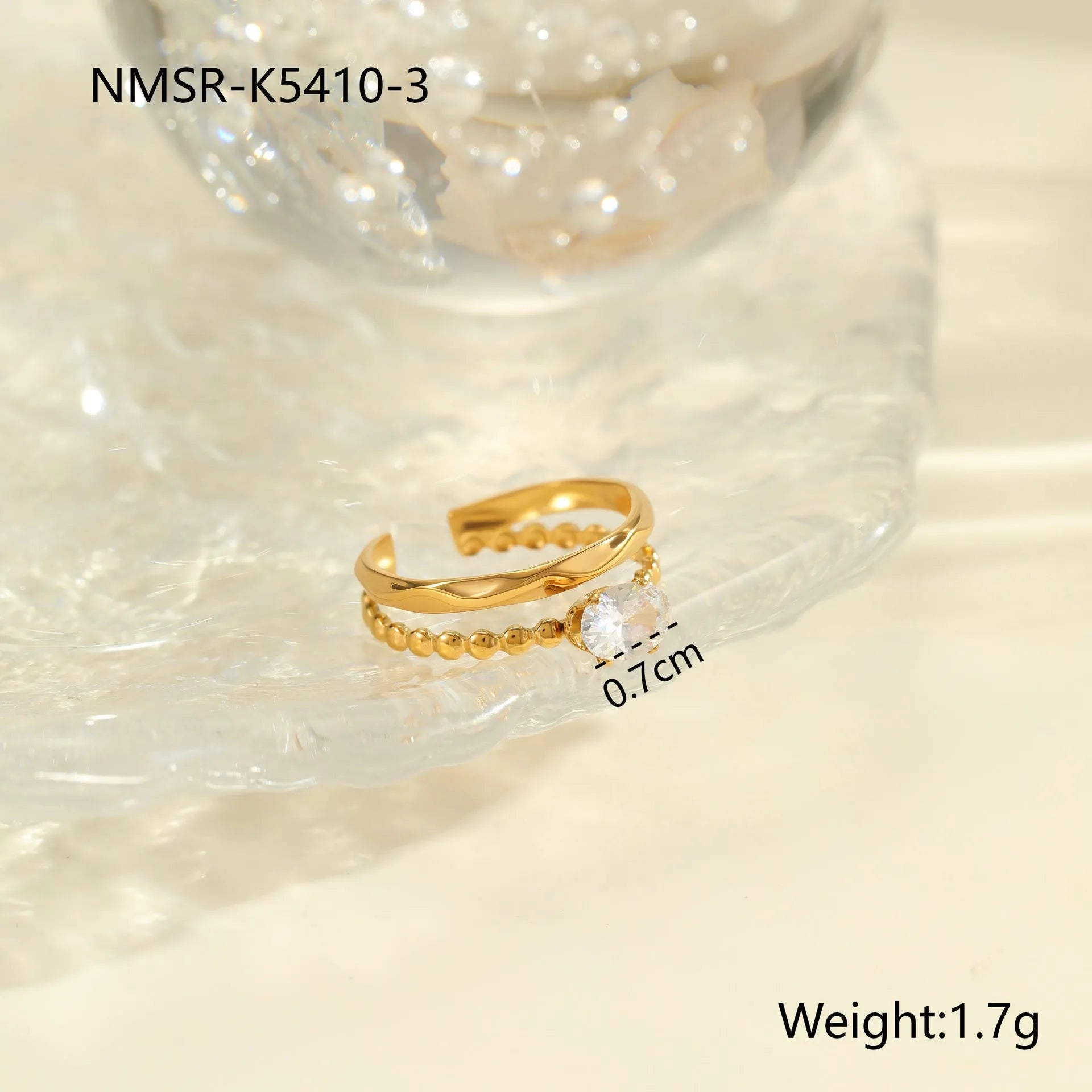 Gold electroplated adjustable ring with geometric zircon design on a stainless steel band.