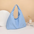 Soft heart-shaped nylon underarm bag for women shown in black, blue, khaki, and yellow.