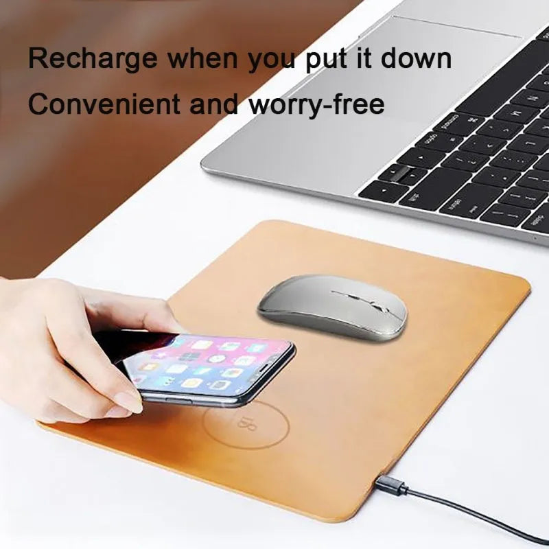 Brown PU leather wireless charging mouse pad with micro-USB cable on a wooden desk.