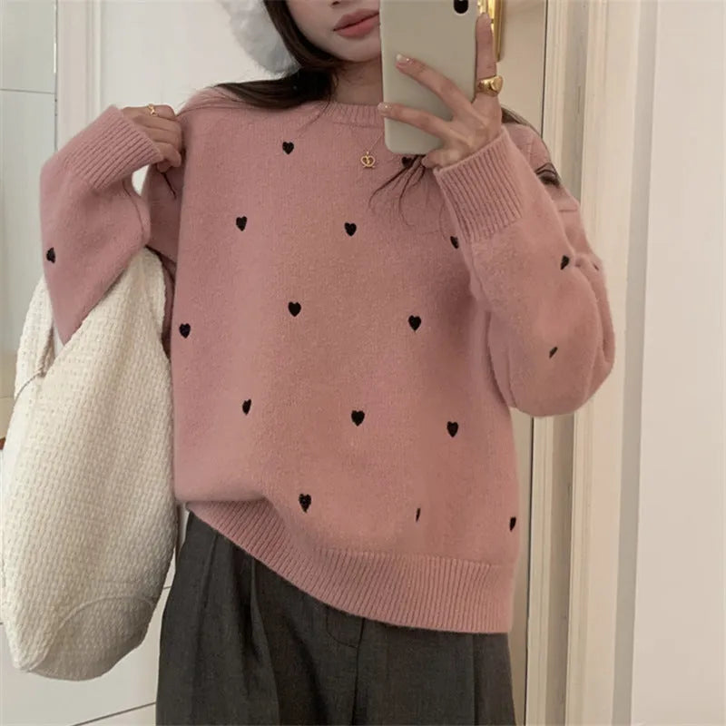 Women's loose fit acrylic pullover sweater in milky white, showing crew neck and long sleeve design.