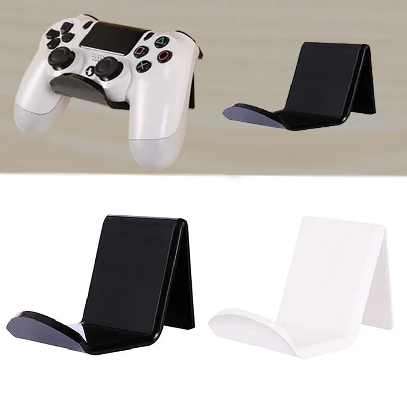 Universal black game controller wall bracket mounted on a wall holding a PlayStation controller.